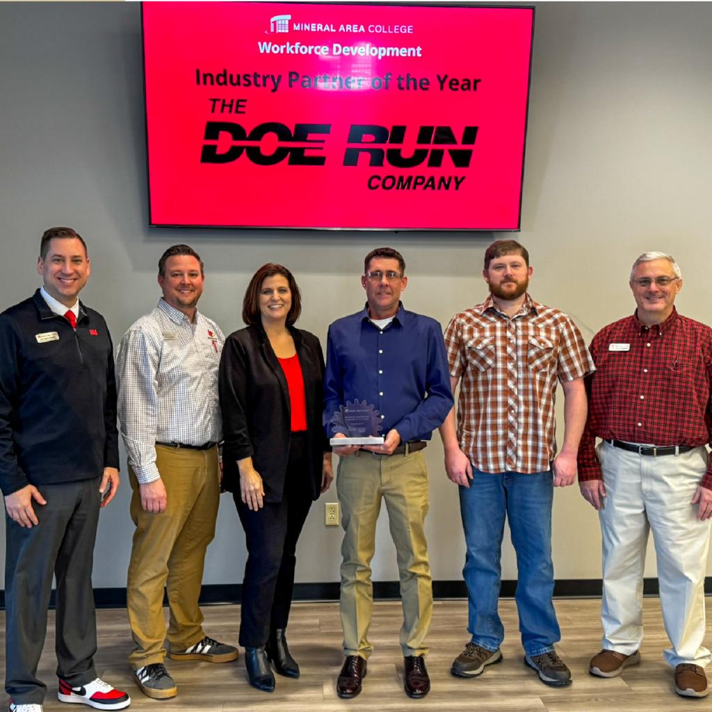 Doe Run Employees Standing in front of Doe Run Sign