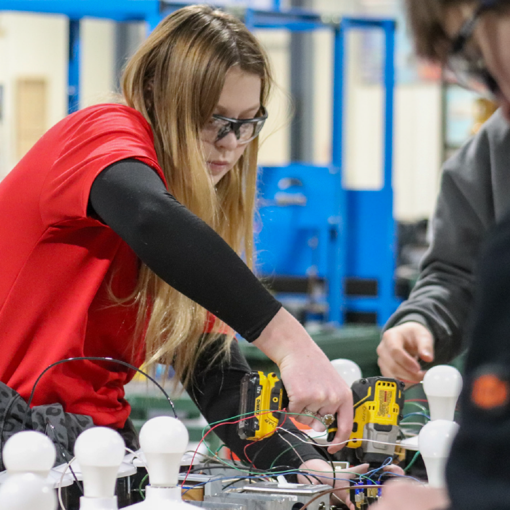 Student Working on Machine Doe Run